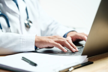 Doctors and nurses for medical concepts, health insurance, family health benefits access and copy space. Doctors diagnose diseases on document and computers.