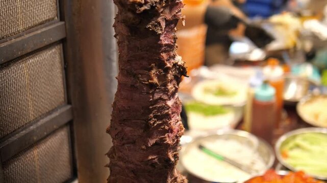 Remaining Shawarma Meat Rotating on Vertical Spit at Street Food Stall &ndash; Close-Up Grill Footage 4K