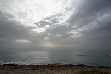 The sea and the sun. The horizon and beautiful clouds in the blue sky. Waves and the wind.