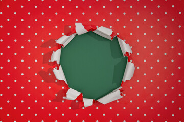 Torn red wrapping paper revealing a green background during holiday gift preparation