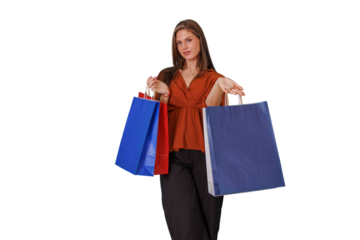 Young woman enjoying successful shopping, holding colorful bags after purchasing products, transparent background