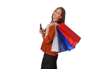 Woman smiling, holding shopping bags and a cell phone, enjoying retail therapy and making a purchase, transparent background