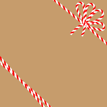 Square craft brown background with candy cane ribbon. Christmas packing string for decoration and present