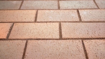 Brick pavement texture pattern forming a repeating background