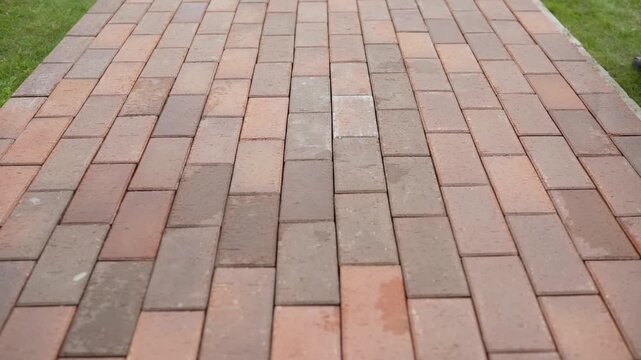 Brick pavement texture pattern forming a repeating background