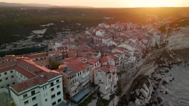 Cinematic Aerial Drone Pan Shot Over the Historic City of Bonifacio Perched on Dramatic Limestone Cliffs at Sunrise, Corsica, France.
