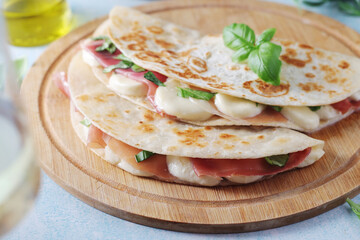 Traditional Italian dish Piadina romagnola - flat bread with mozarella and proscuitto