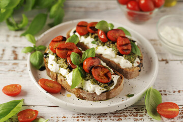 Italian sandwiches with grilled tomatoes, burrata cheese and pesto	