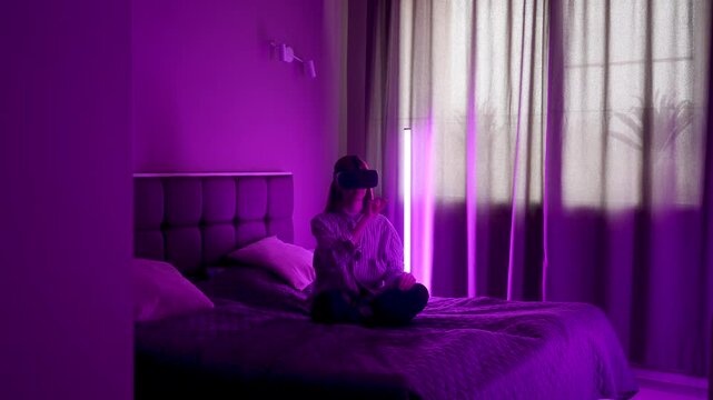 Browsing the internet in virtual reality while sitting on a bed in a purple room