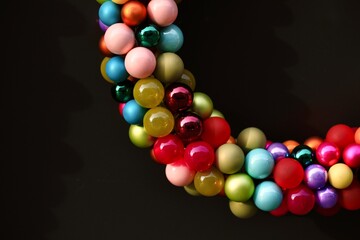 Minimalist multicolor Christmas baubles garland on Dark Background