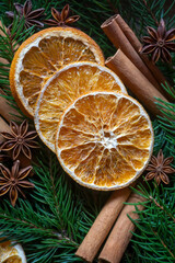 Dried orange slices, cinnamon, anise on spruce branches.