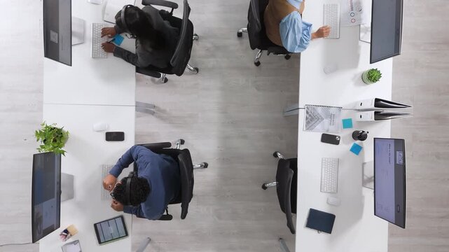 Call center, agent and people with headset, coworking and help with troubleshooting on web or above. IT team, discussion and group with mic for tech support, contact us and communication in office