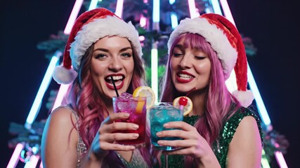 two caucasian women in santa hats clinking colorful cocktails, neon party backdrop, sequined dresses, glitter makeup, smiling and laughing, closeup portrait capturing festive joy, bar lighting, drink. - Powered by Adobe