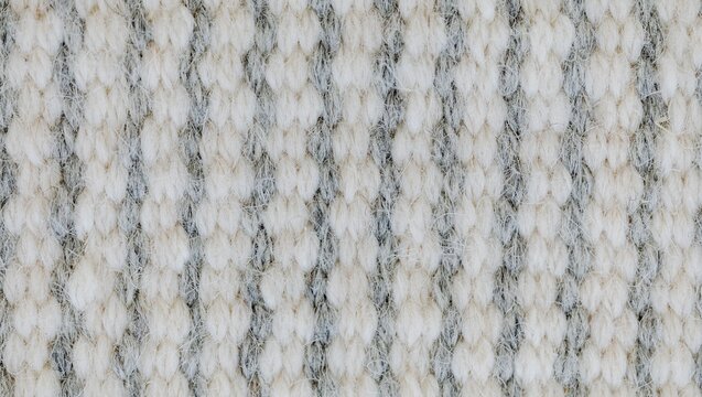 Close up shot of a textured white and gray carpet pattern with vertical stripes and looped pile fibers