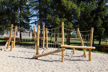 Children's playground with wooden swings.