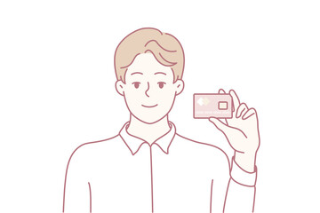 man taking selfie with compact camera smiling toward lens, presenting confident pose for profile update or vlog thumbnail clean studio vibe with focus on expression, framing, lens