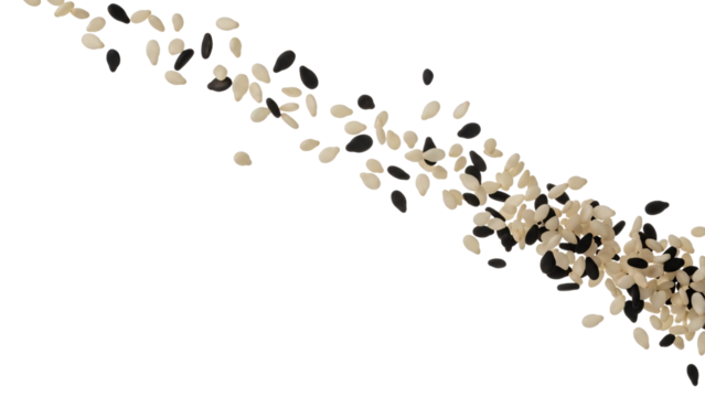 A diagonal stream of mixed black and white sesame seeds scattered and isolated on a white background.