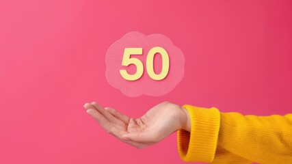 Video A person holding a sign with the number 50, great for various occasions and events