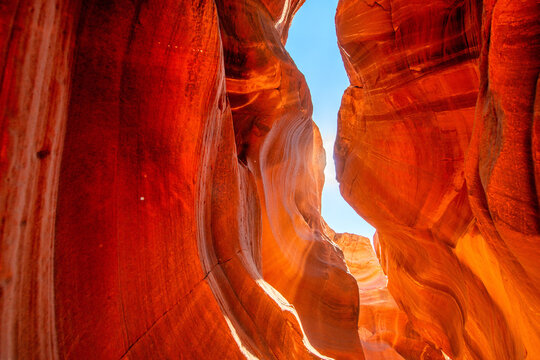 Spectacular Antelope Canyon interior with light beams illuminating red sand and sculpted rock walls