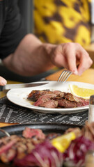 Close up of sliced tagliata beef steak served on a plate in fine dining restaurant