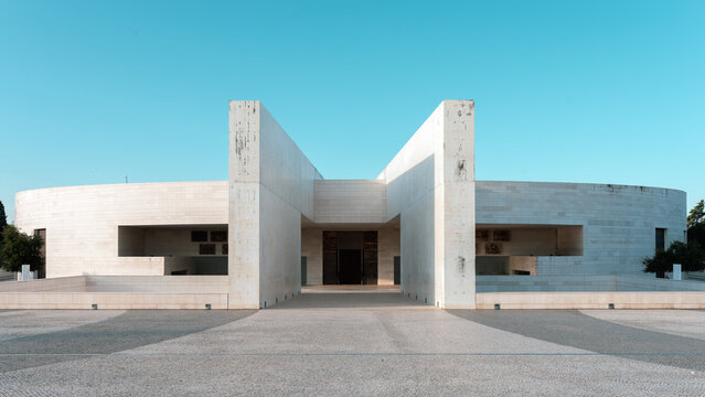Fatima, Portugal - 22nd October, 2019, Front view of modern Basilica of the Holy Trinity at Sanctuary of F&aacute;tima, contemporary white circular church with minimalist architecture on sunny plaza