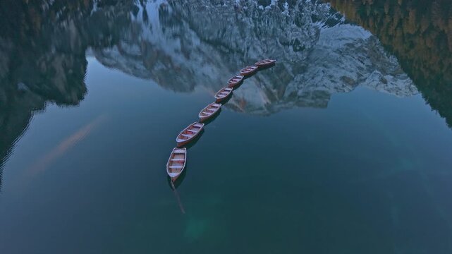 Scenic drone shot of Lake Braies with golden forest, Italy