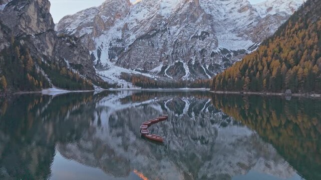 Drone view of alpine lake Braies with autumn trees, Italy