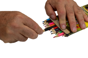 A man takes a colored pencil from a box lying on a PNG background.