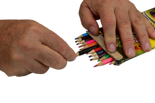 A man takes a colored pencil from a box lying on a PNG background.
