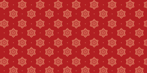 Elegant seamless pattern with golden snowflakes and tiny stars on a rich red background, perfect for Christmas wrapping paper, festive textiles, greeting cards, invitations and seasonal holiday design