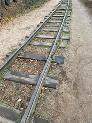 Old railway rails closeup on a grass