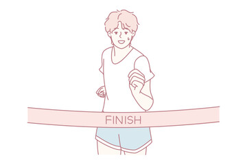 runner crossing finish ribbon, celebrating personal victory at local charity run with arms raised and smiling