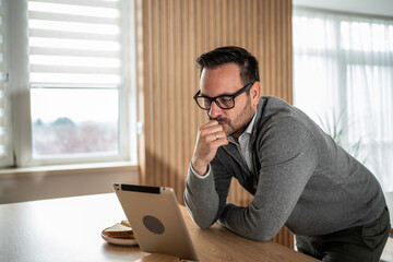 Man working on tablet at home office