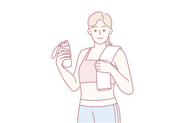 barista holding takeout cup and smartphone while wearing apron, offering drink with welcoming smile.