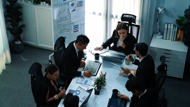 Top view of smart manager project writing at chart while looking at data. Project manager explain marketing idea while diverse skilled investors or analyst analyze stock investment chart. Directorate. - Powered by Adobe