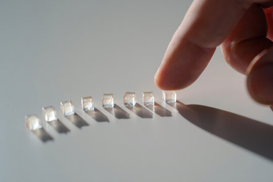 Finger touching cube array on white surface in close up view Concept of business solutions Innovation future technology and strategy