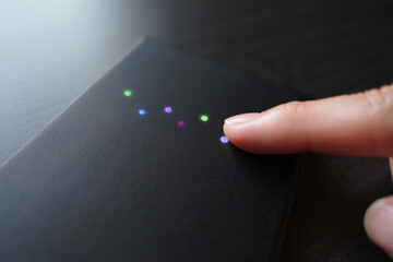 Fingertip Touching Light Emitting Diodes Placed on Black Surface Concept for Modern Technology and Electronics Close up