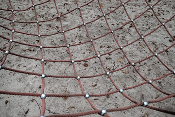 Close up of a net on a playground for children to play.