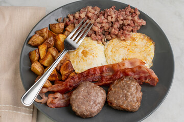 eggs over easy with home fries and corn beef hash