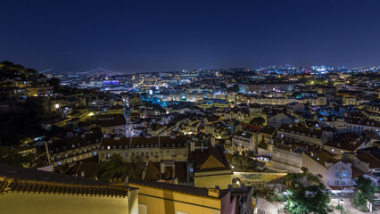 Lisbon panorama after sunset aerial view of city centre with red roofs at autumn day to night timelapse, Portugal