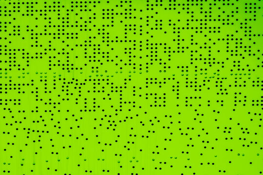 a bright green background with a dense pattern of small, evenly spaced black dots.