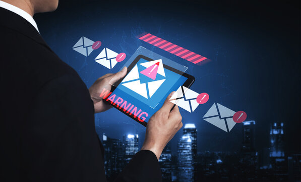 A businessman interacts with a tablet displaying a warning symbol amidst email notifications. The image highlights concerns of digital communication, security, and risk management. Gantry - Powered by Adobe