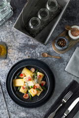 Calamarata pasta with shrimp, asparagus, and chili on plate