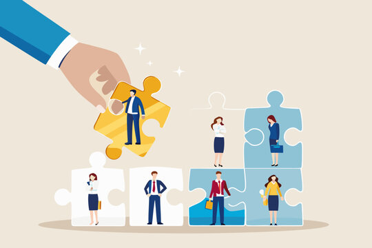 Hand placing a golden puzzle piece with a businessman into a team of diverse professionals