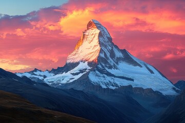A mountain peak covered in snow at sunset with a pink and orange sky in the background view landscape