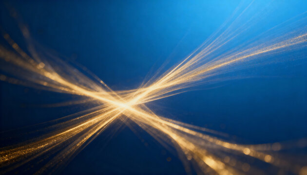 Abstract golden light streams on a blue background. Luminous sparkling particles in dynamic motion. Technology and energy concept