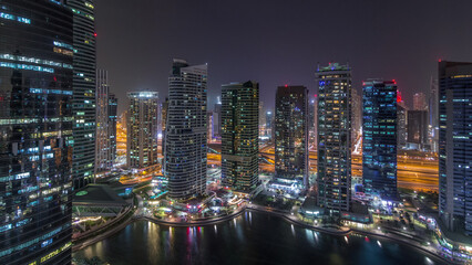 Naklejka premium Residential and office buildings in Jumeirah lake towers district day to night timelapse in Dubai