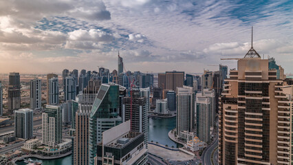 Obraz premium Dubai Marina skyscrapers and jumeirah lake towers view from the top aerial timelapse in the United Arab Emirates.