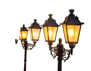 Four ornate street lamps with illuminated amber lights against a dark, empty background. The lamps diminish in size