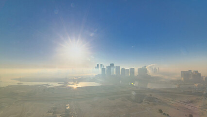 Abu Dhabi city skyline with skyscrapers at sunrise from above timelapse
